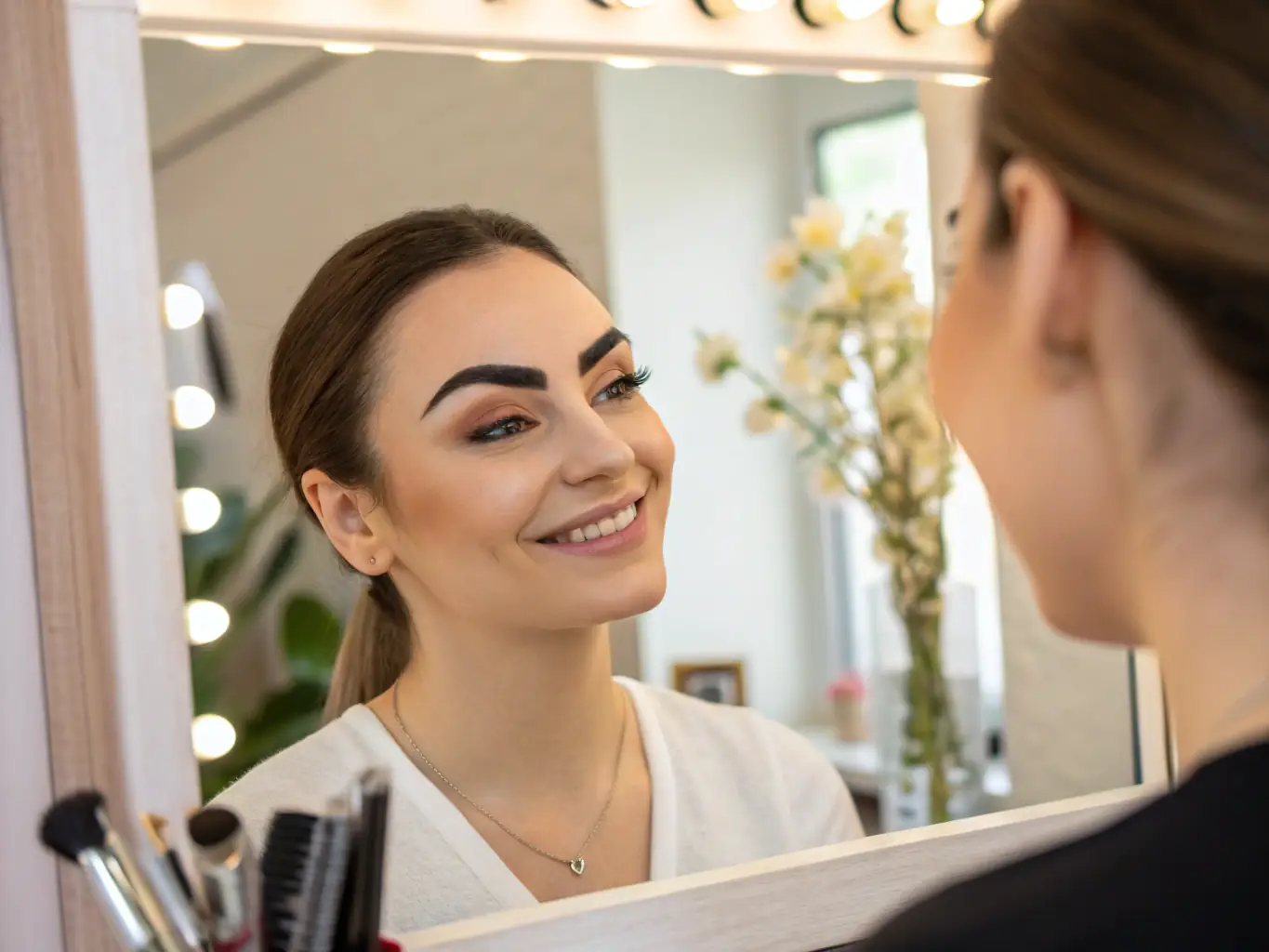 A close-up shot of perfectly shaped eyebrows after an eyebrow shaping and tinting session, highlighting the precision and artistry involved.
